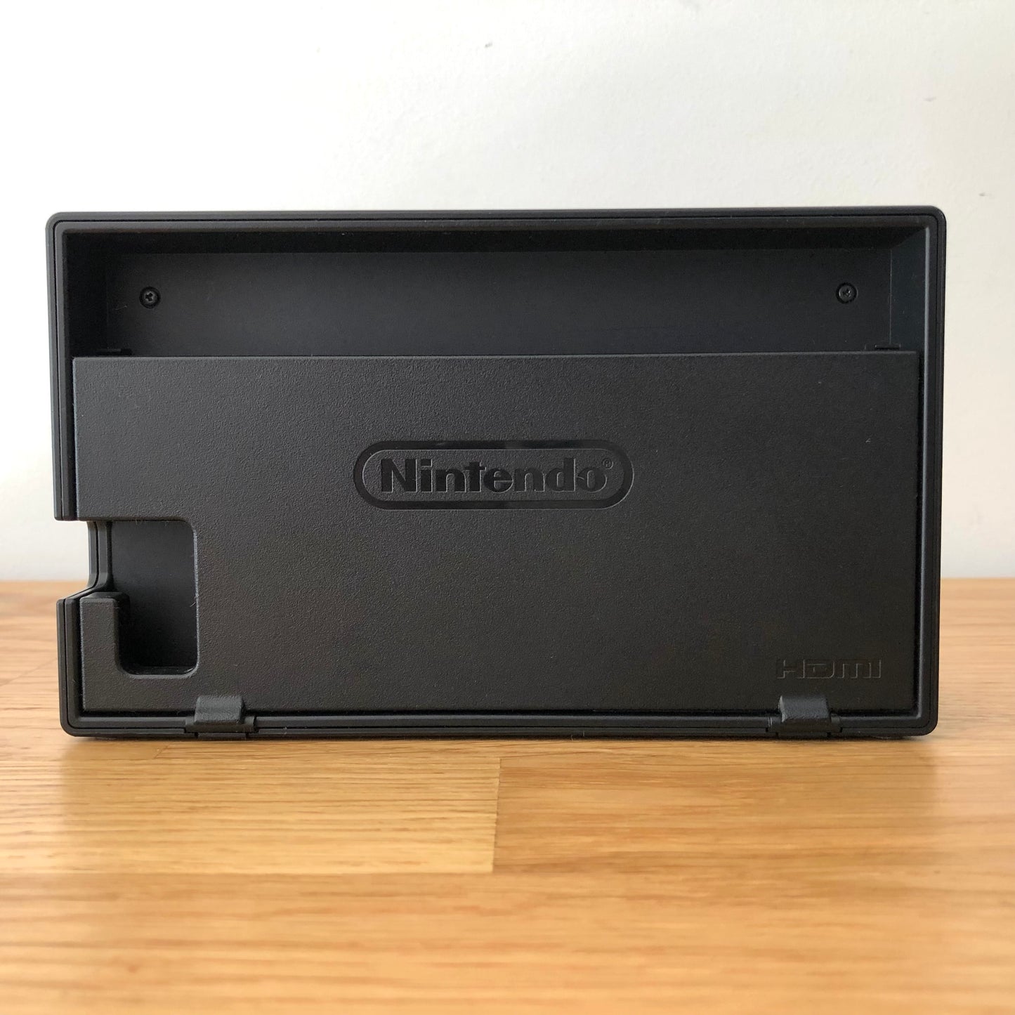 Rear of Nintendo Switch dock with HDMI branding and Nintendo logo, cable slot openings on left side.