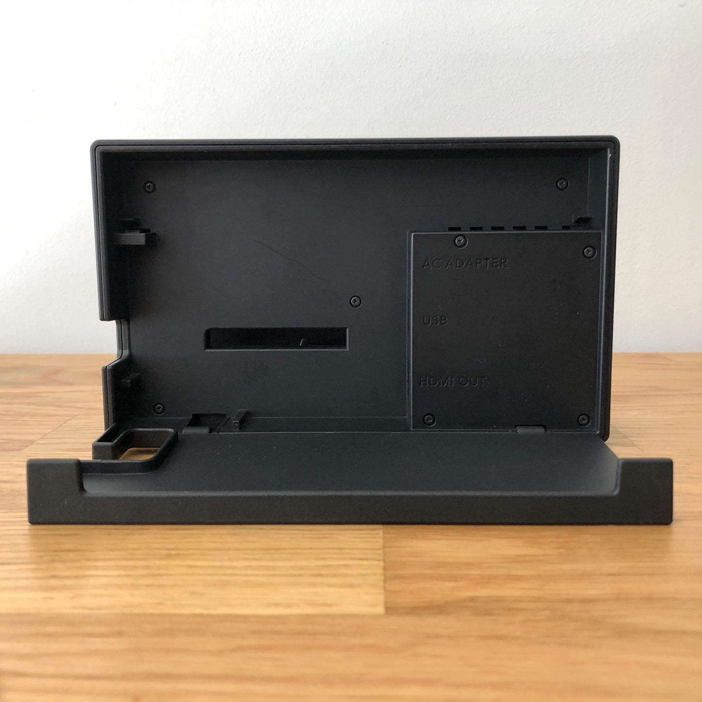 Rear of Nintendo Switch dock with HDMI branding and Nintendo logo, cable slot openings on left side.