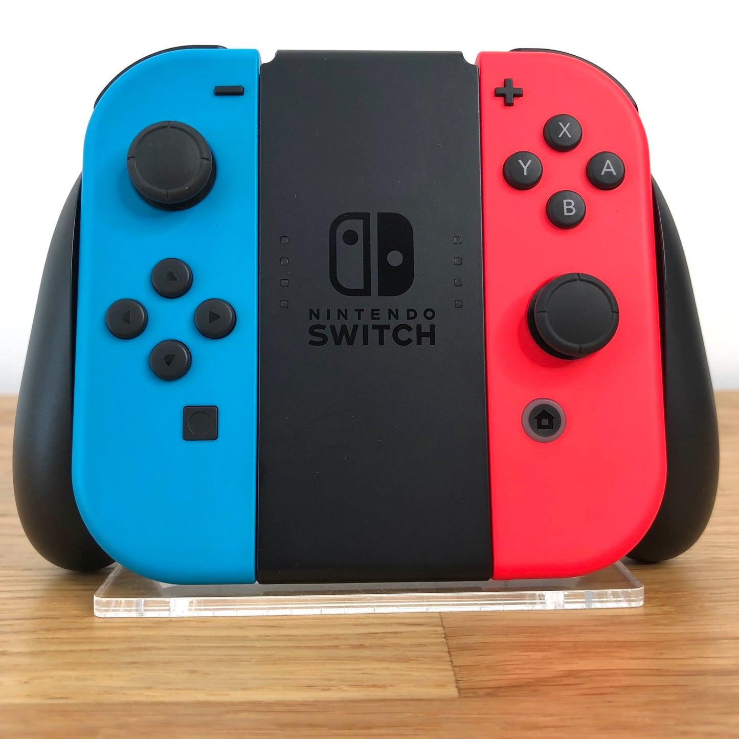 Front view of Joy-Con grip with neon red and blue Nintendo Switch Joy-Cons, showing all front facing buttons.