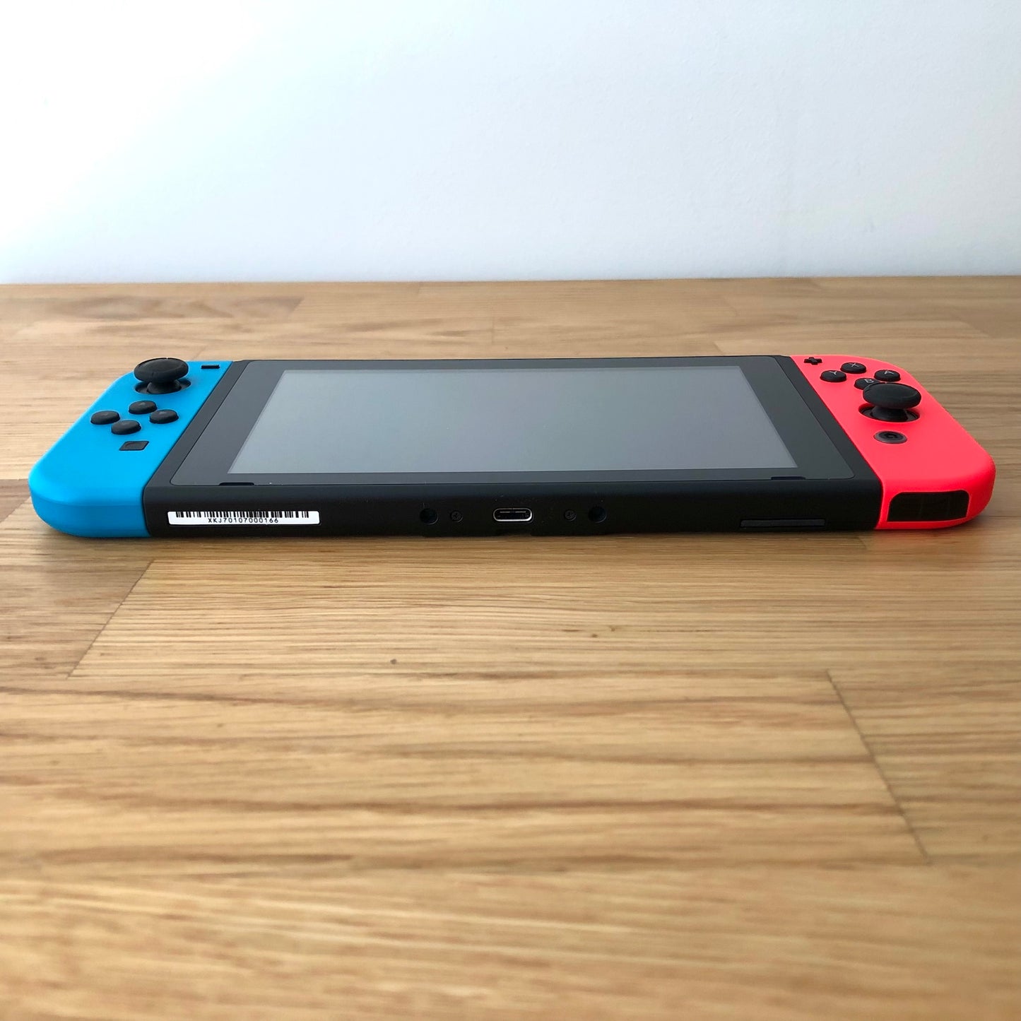 Bottom edge of Nintendo Switch showing USB-C port, speaker grills, and lower edge of both Joy-Cons.