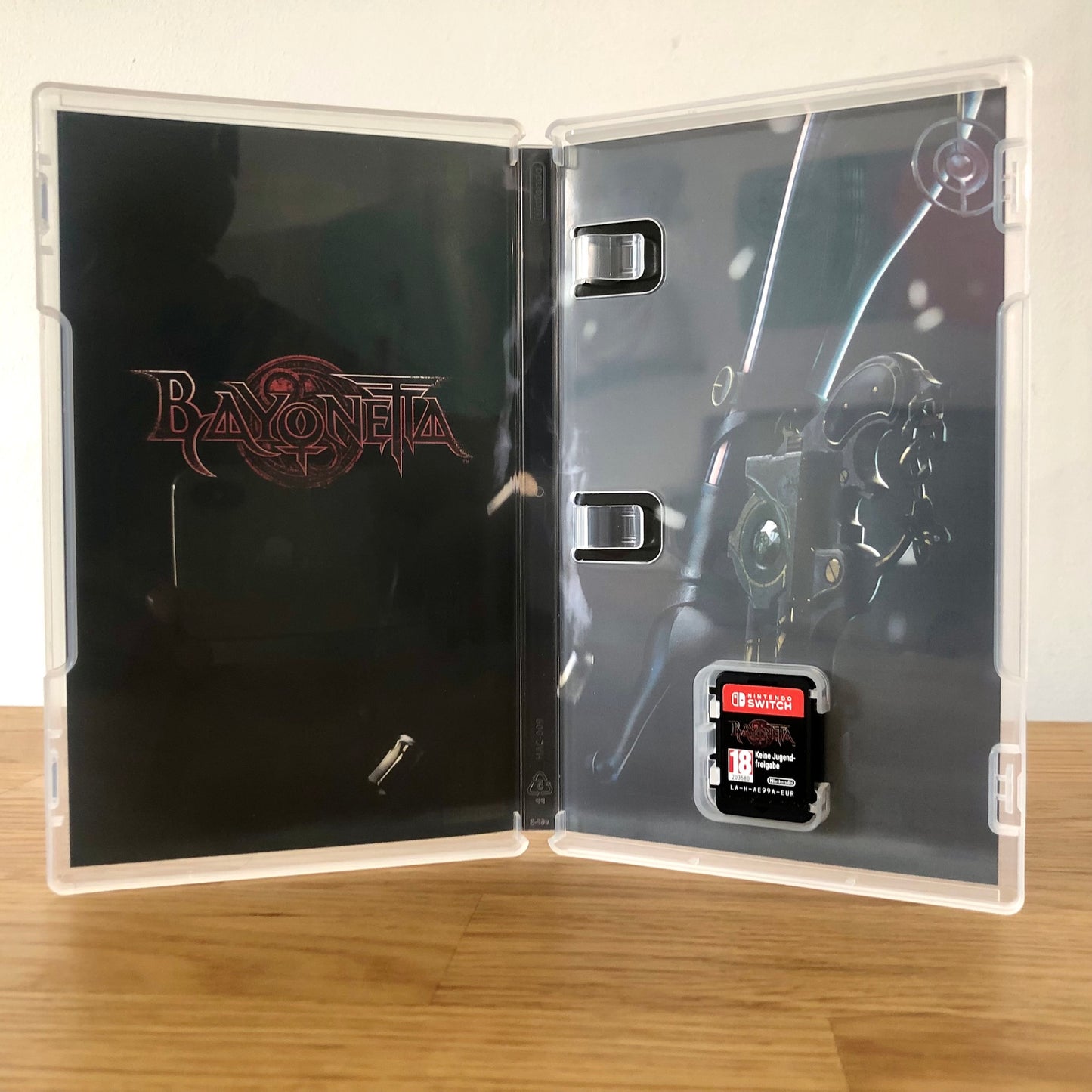 Inside the case of Bayonetta for Nintendo Switch, showing the cartridge and case design.