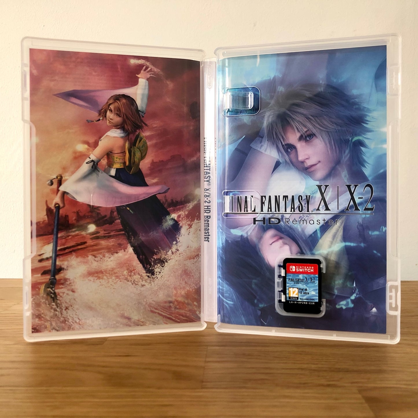Inside the case of Final Fantasy X/X-2 HD Remaster for Nintendo Switch, showing the cartridge and case design.
