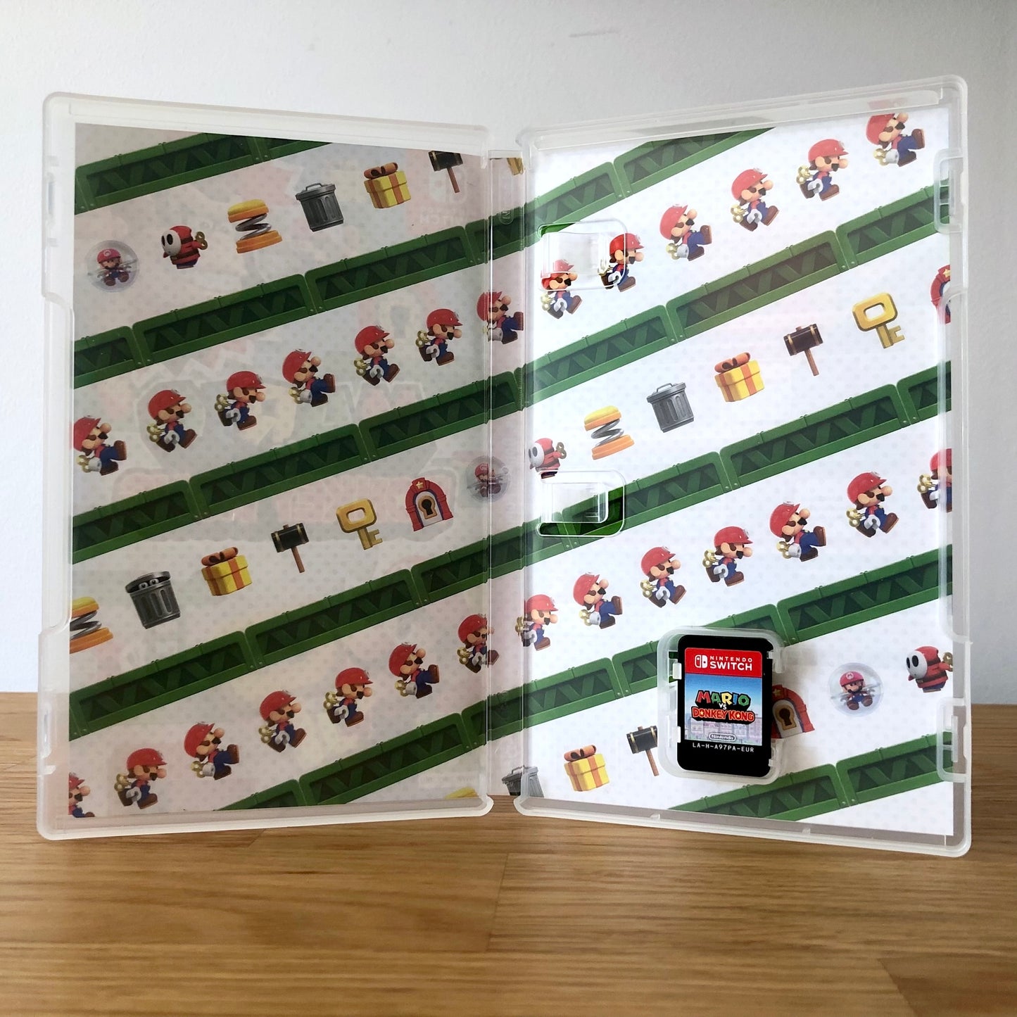 Inside the case of Mario vs Donkey Kong for Nintendo Switch, showing the cartridge and case design.