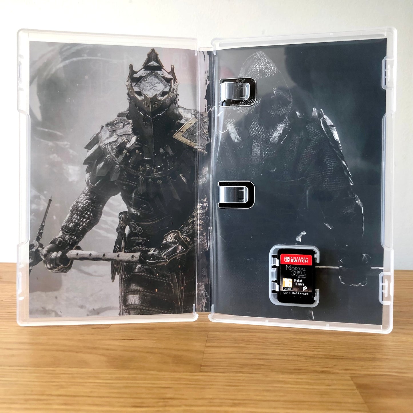 Inside the case of Mortal Shell: Complete Edition for Nintendo Switch, showing the cartridge and case design.