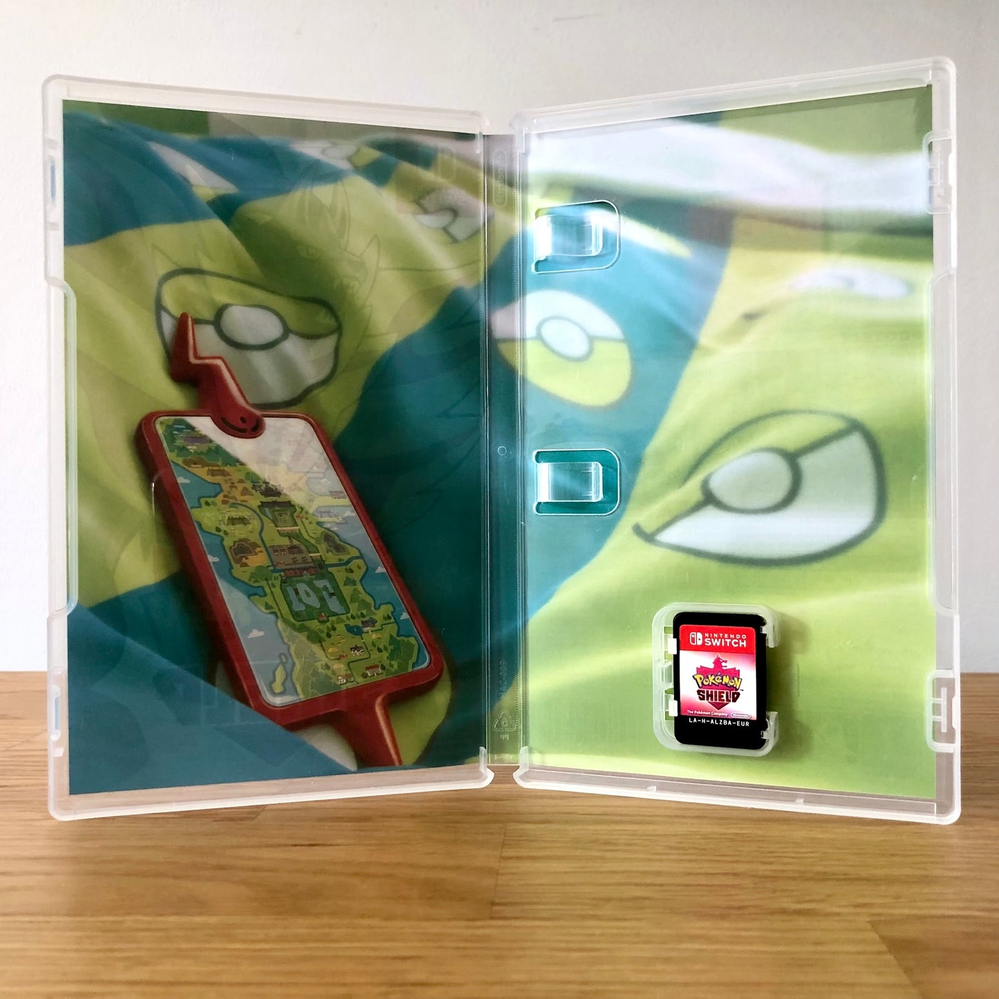 Inside the case of Pokémon Shield for Nintendo Switch, showing the cartridge and case design.