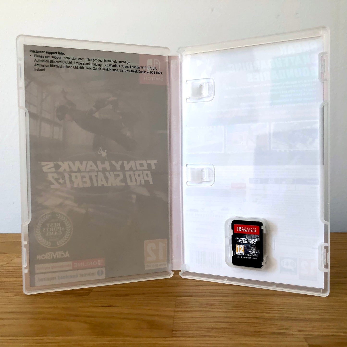 Inside the case of Tony Hawk's Pro Skater 1 + 2 for Nintendo Switch, showing the cartridge and case design.