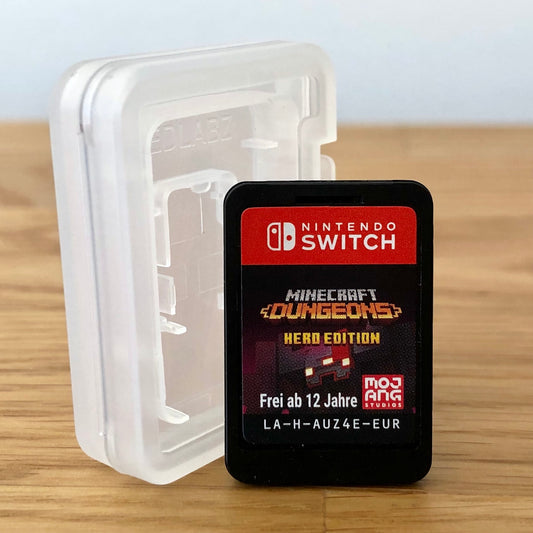 Nintendo Switch game card for 'Minecraft Dungeons Hero Edition' in a clear case on a wooden surface.
