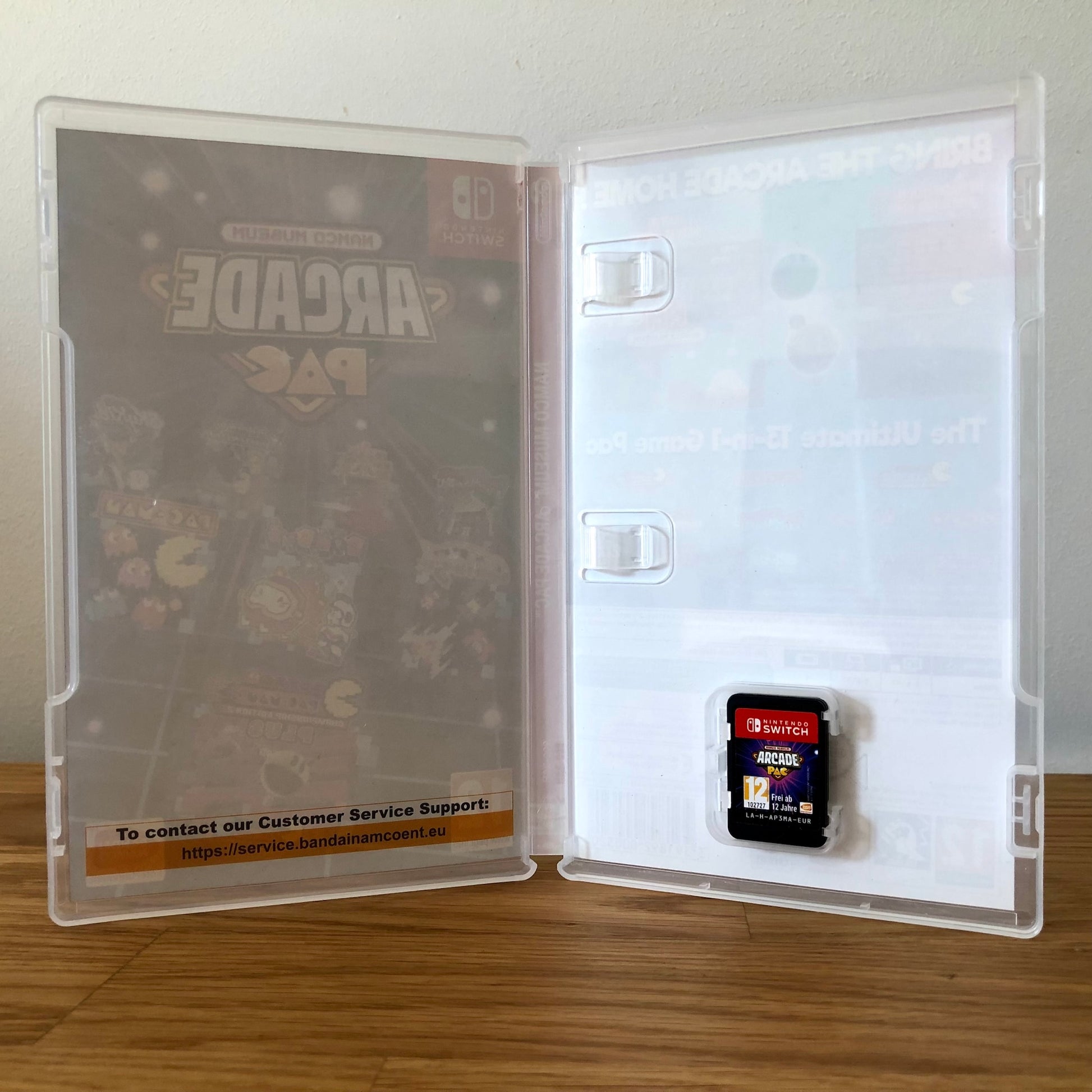 Inside the case of Namco Museum Arcade PAC for Nintendo Switch, showing the cartridge and case design.