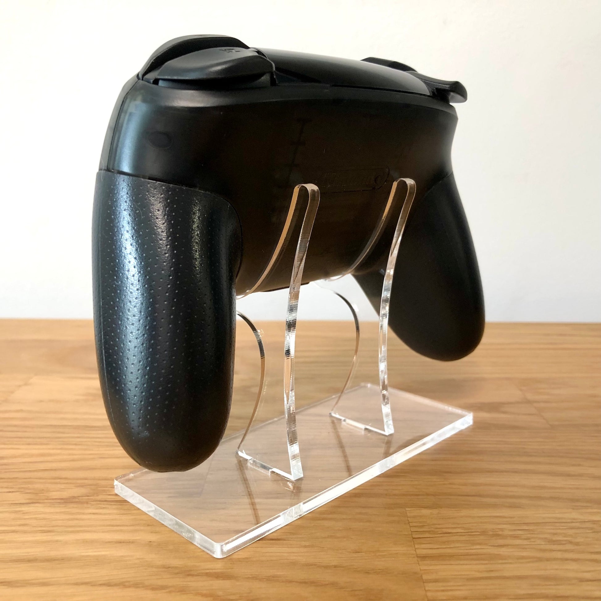 Back side view of Nintendo Switch Pro Controller, highlighting model details and rear design.