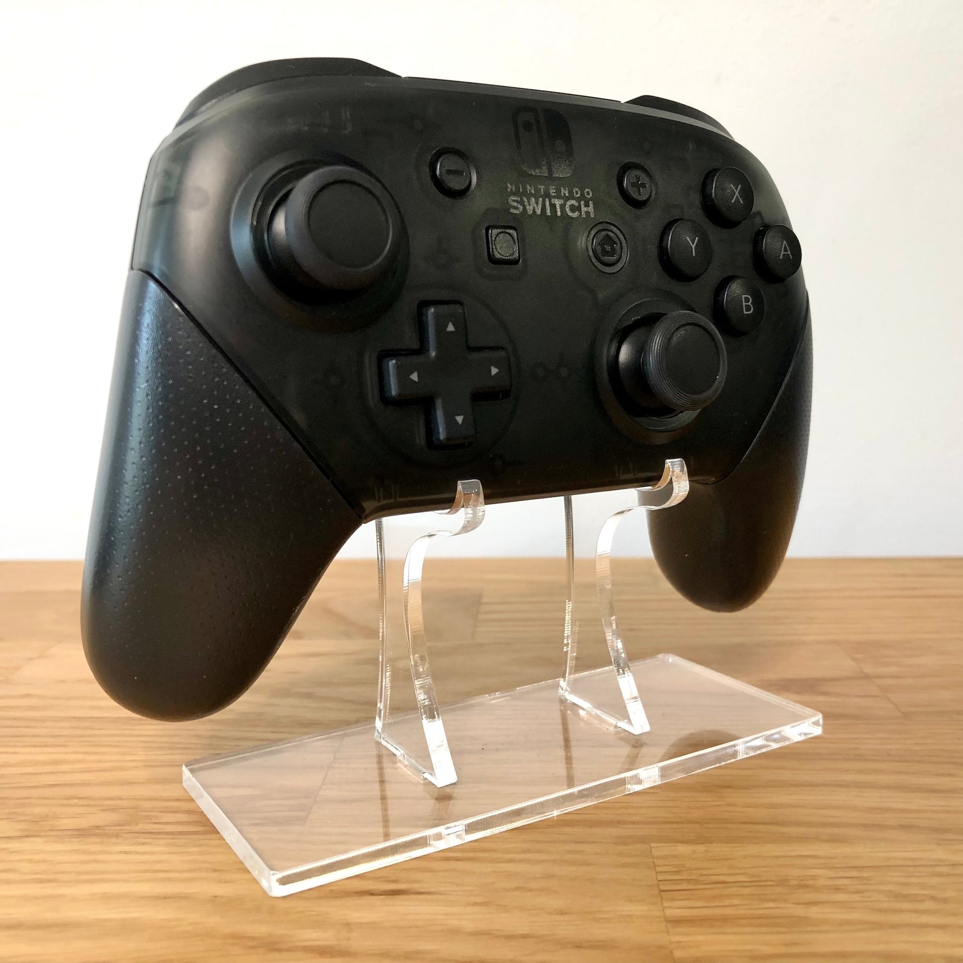 Front side view of Nintendo Switch Pro Controller, showing button layout and ergonomic design.