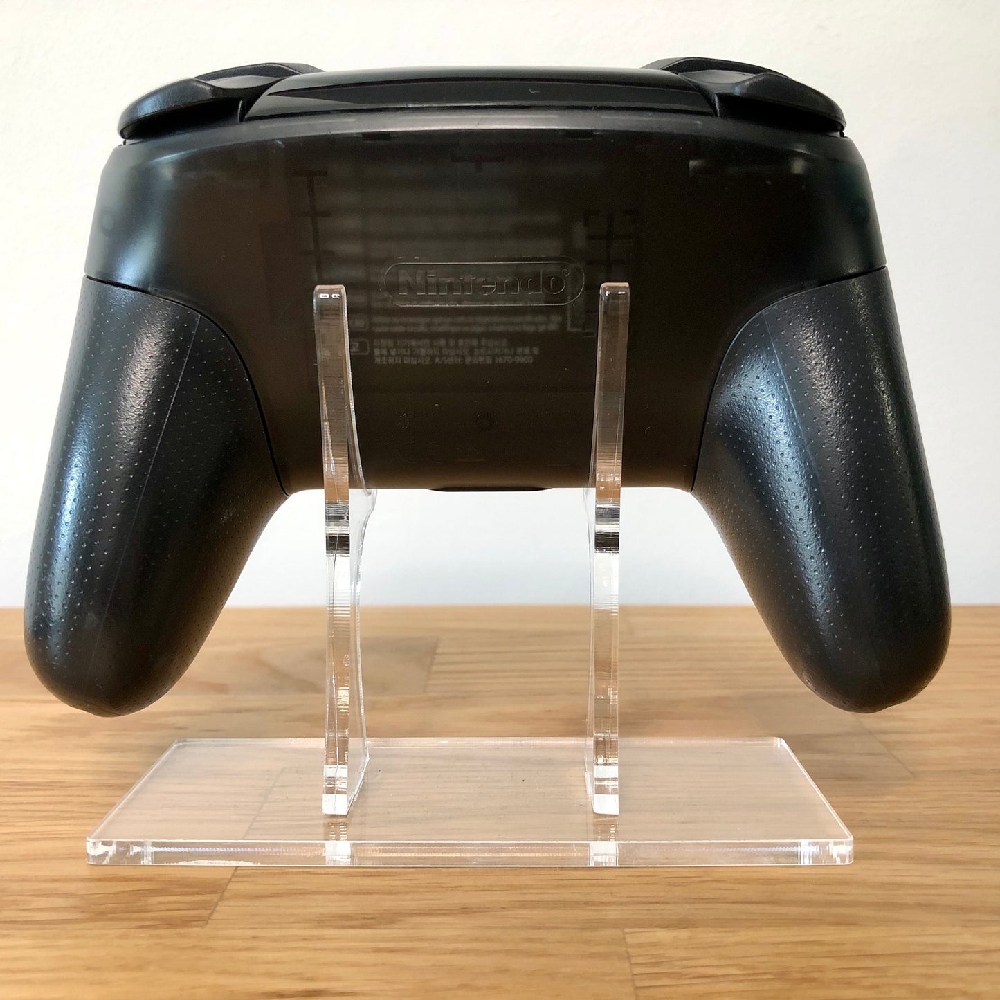 Back view of Nintendo Switch Pro Controller, highlighting model details and rear design.
