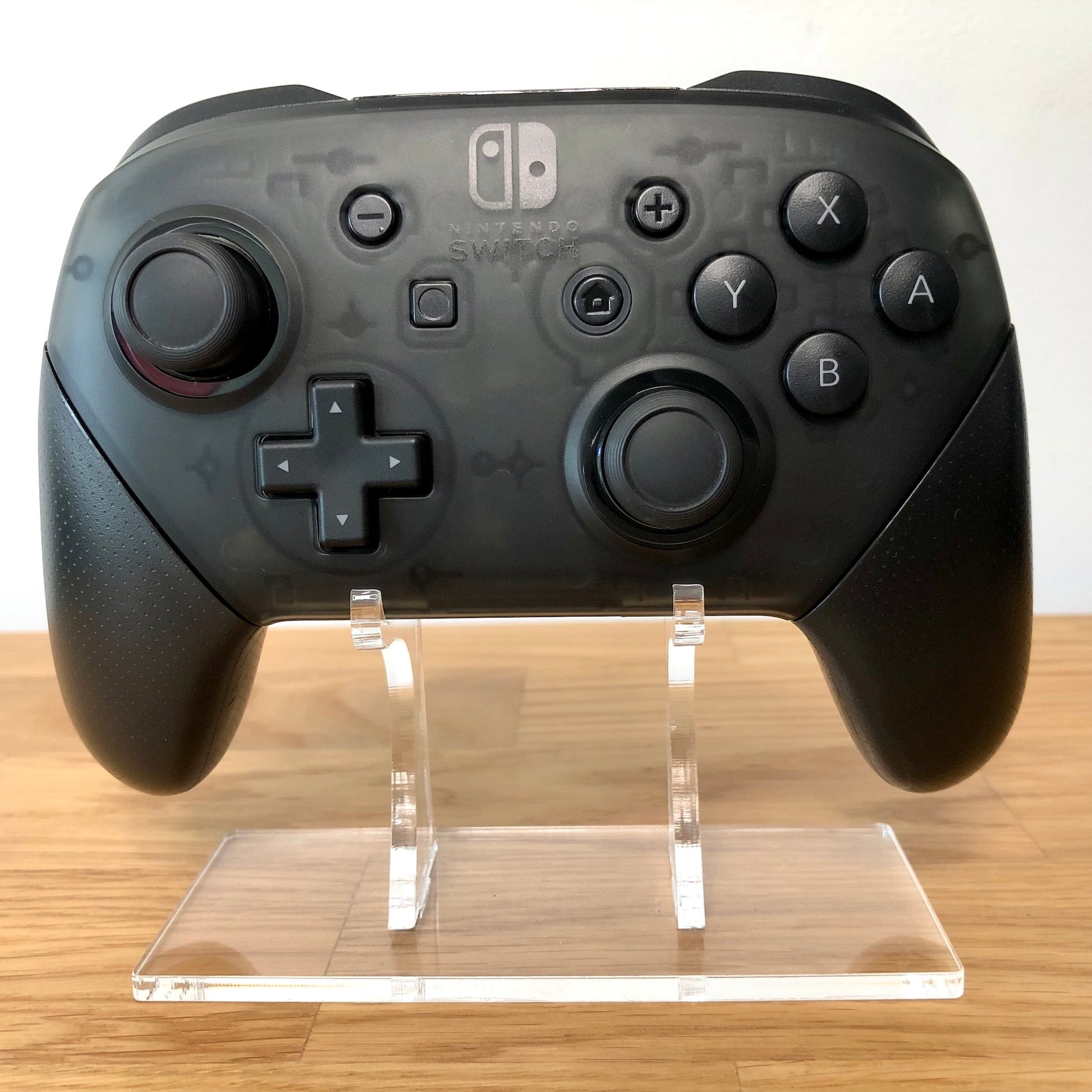 Front view of Nintendo Switch Pro Controller, showing button layout and ergonomic design.