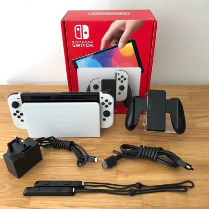 White Nintendo Switch OLED console with original box, Joy-Con grip, charger, HDMI cable and straps included.