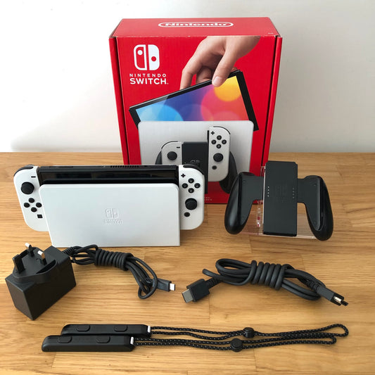 White Nintendo Switch OLED console with original box, Joy-Con grip, charger, HDMI cable and straps included.