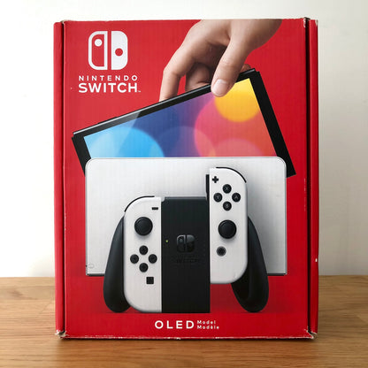 Front of Nintendo Switch OLED box showing white console and Joy-Cons, with colourful screen artwork and red background.