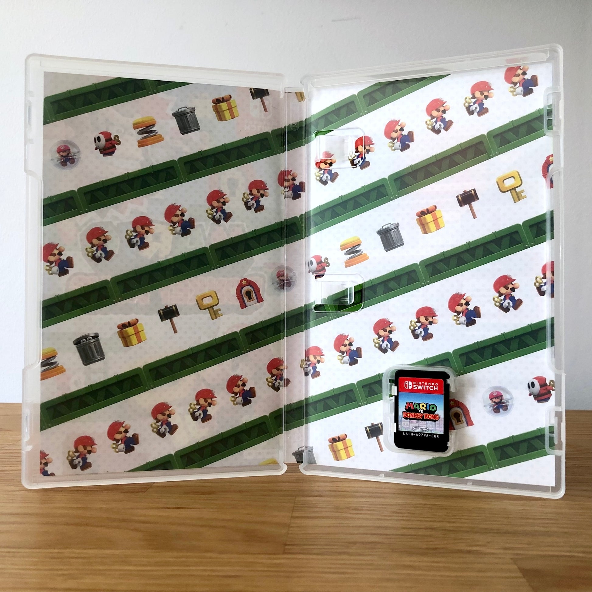 Inside the case of Mario vs Donkey Kong for Nintendo Switch, showing the cartridge and case design.